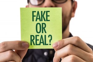 man holding a post it note