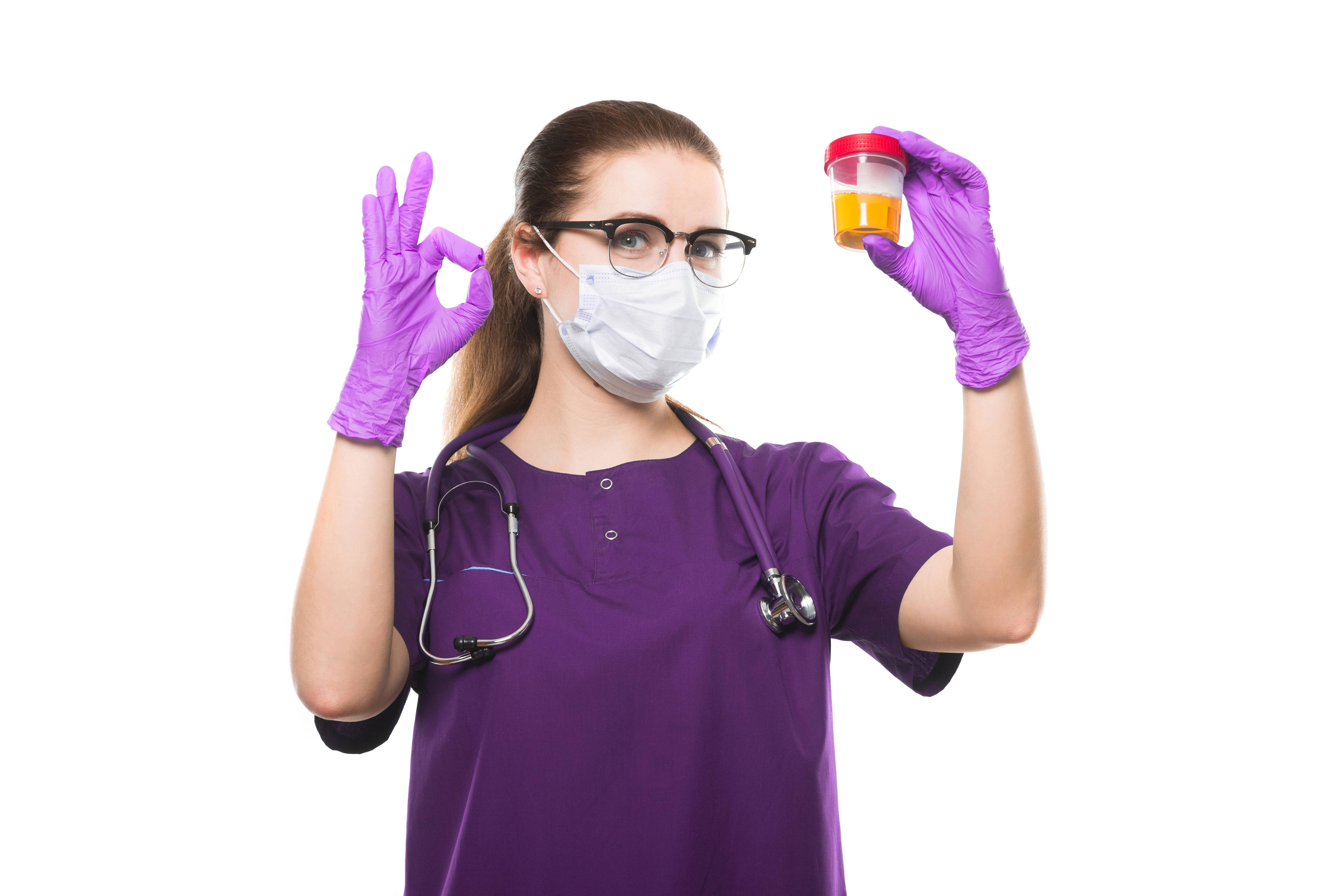 women in scrubs signing okay and hold urine sample in opposite hand