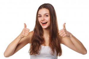 happy young woman showing thumbs up