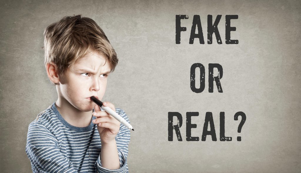 confused young boy if it is fake or real?