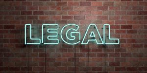 LEGAL - fluorescent Neon tube Sign on brickwork