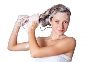 Woman shampooing hair