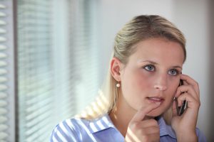 Thoughtful women making phone call