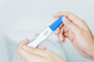 Woman checking pregnancy test