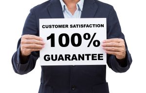 Business man hand holding paper customer satisfaction 100% guarantee