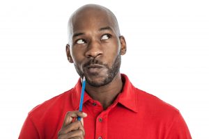 late 20s black man with pencil on chin thinking 