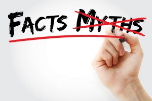 Hand writing Facts Myths with marker.