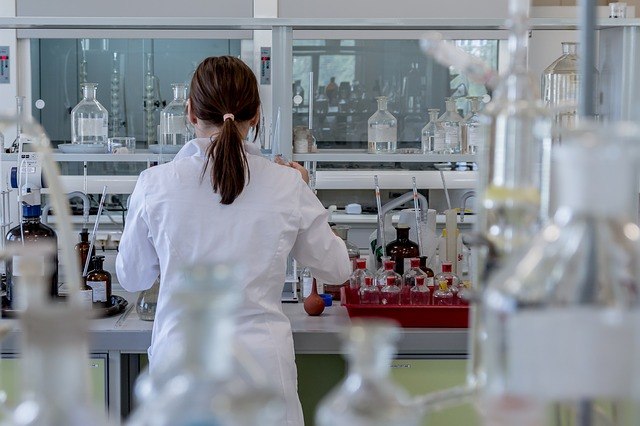 Ponytailed lady at the lab facing backwards